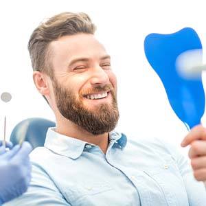 man looking at the final restoration for dental implant