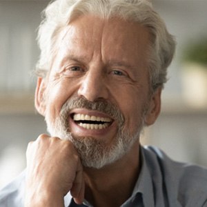 man smiling with implant dentures 