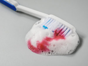 Blood and toothpaste on toothbrush