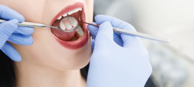 Woman getting an exam from a dentist in East Islip