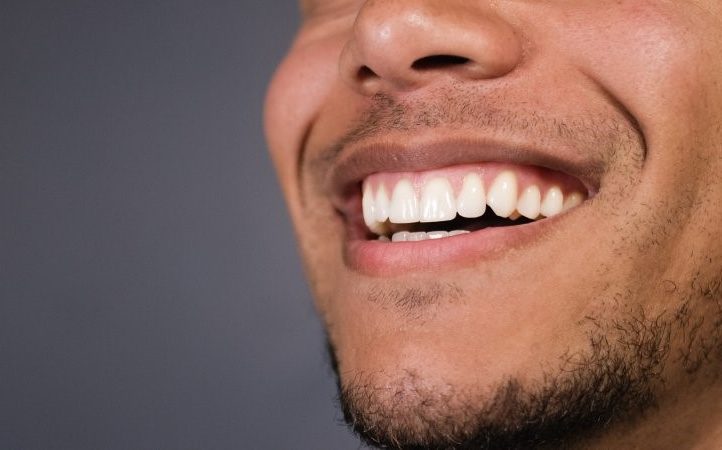 closeup of person with dental crown smiling